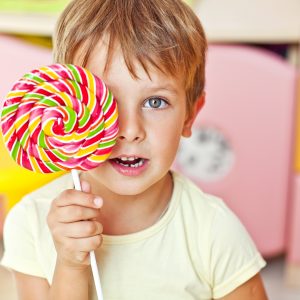 Happy kid with a big candy